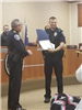 Police Officer Holding up a Certificate