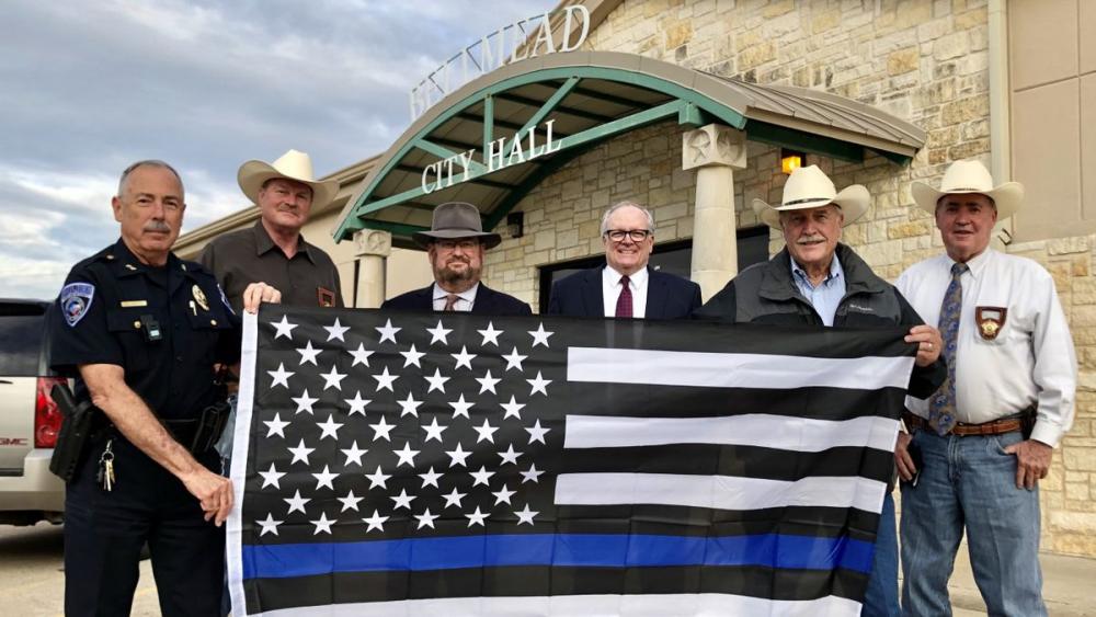 Men Holding Thin Blue Line Flag